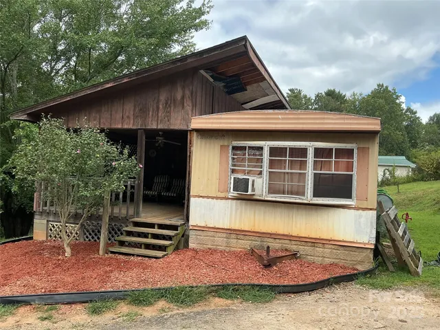 a backyard of a house with yard barbeque oven and outdoor seating