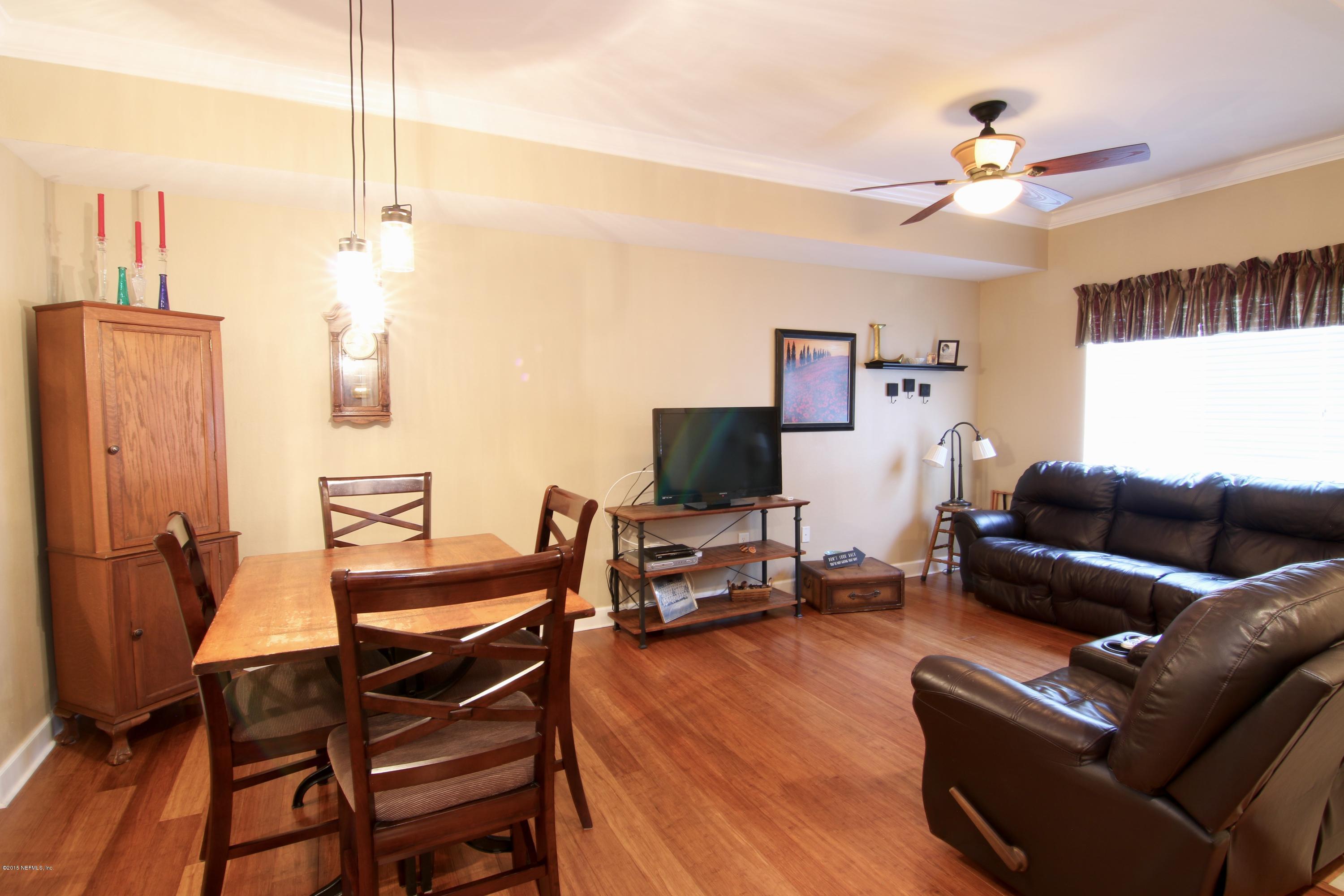 9745 Touchton Road, Unit 1104 Jacksonville, FL 32246 - Photo 4 of 19 a living room with furniture a flat screen tv and a window