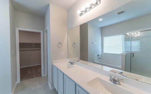 a bathroom with a double vanity sink mirror and double