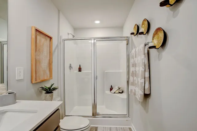 a picture of a bathroom with a shower and a mirror