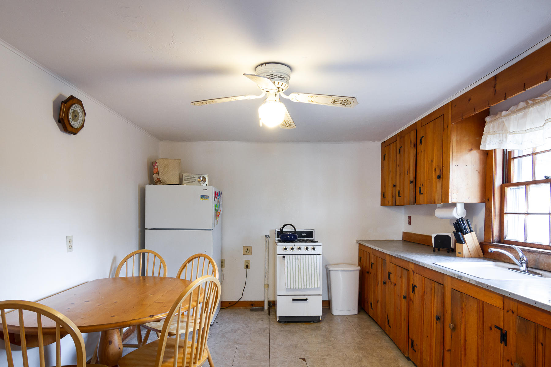 73 Santucket Road West Dennis, MA 02670 - Photo 18 of 36 a kitchen with stainless steel appliances granite countertop a stove a sink a dining table and chairs with wooden floor