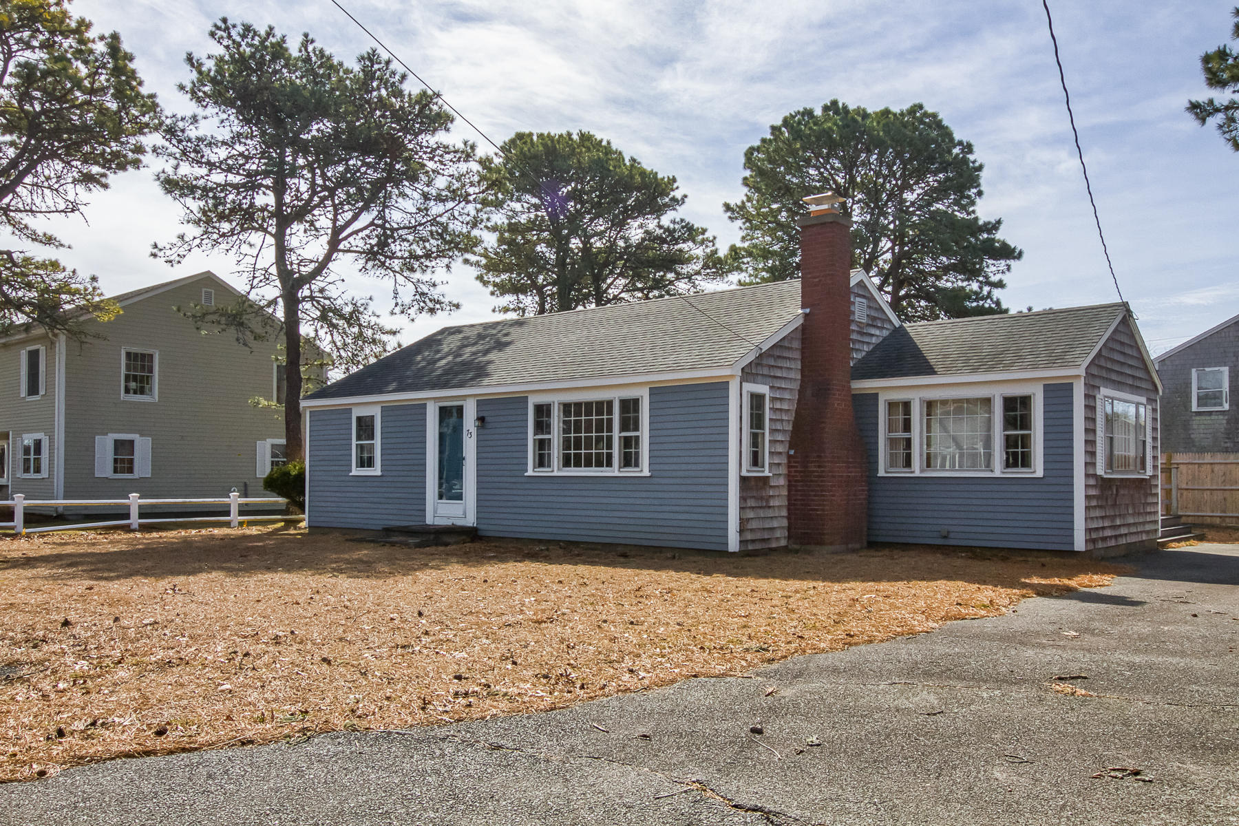 73 Santucket Road West Dennis, MA 02670 - Photo 2 of 36 a house that has a tree in front of it