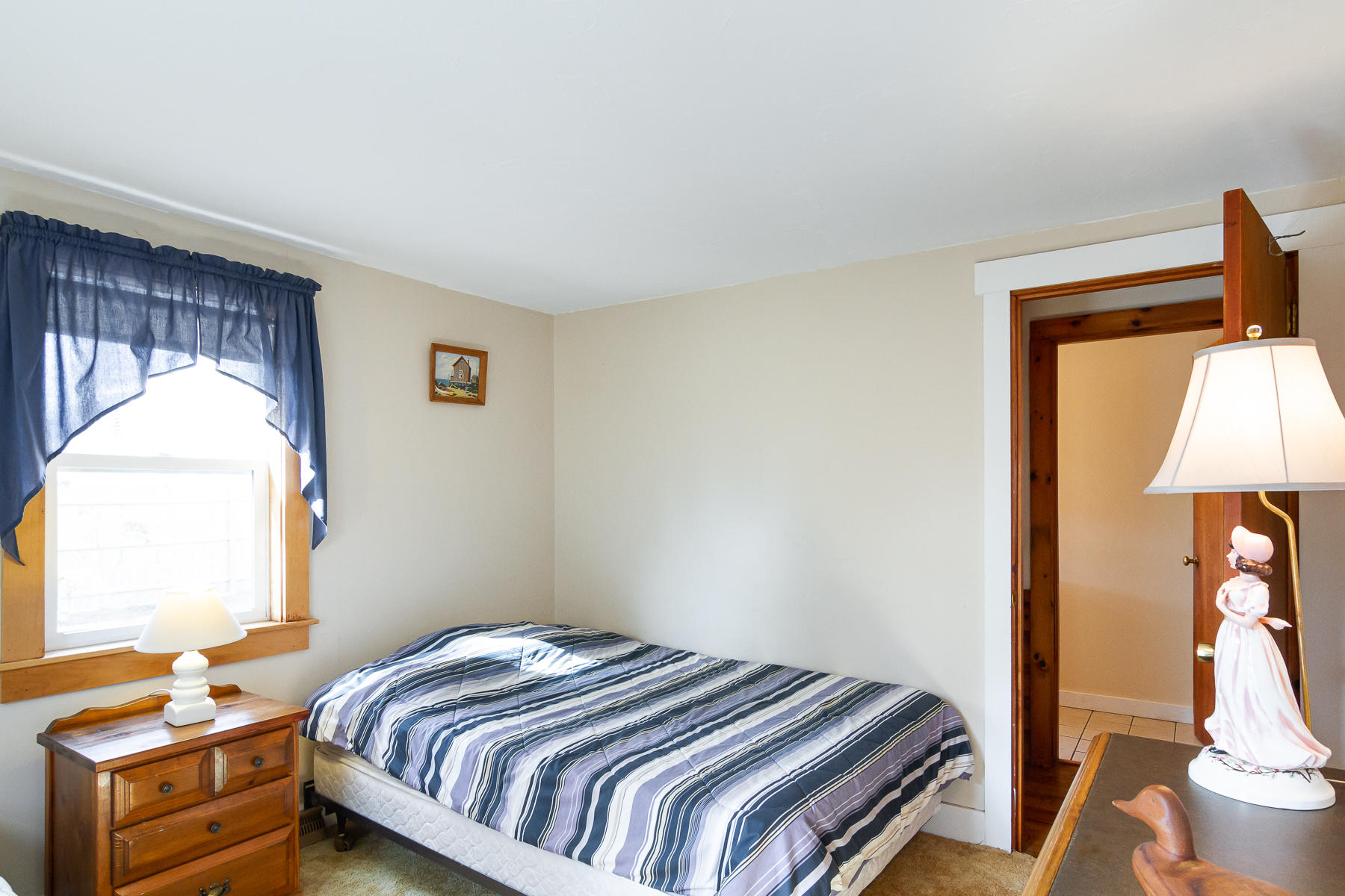 73 Santucket Road West Dennis, MA 02670 - Photo 26 of 36 a bedroom with a bed and a lamp