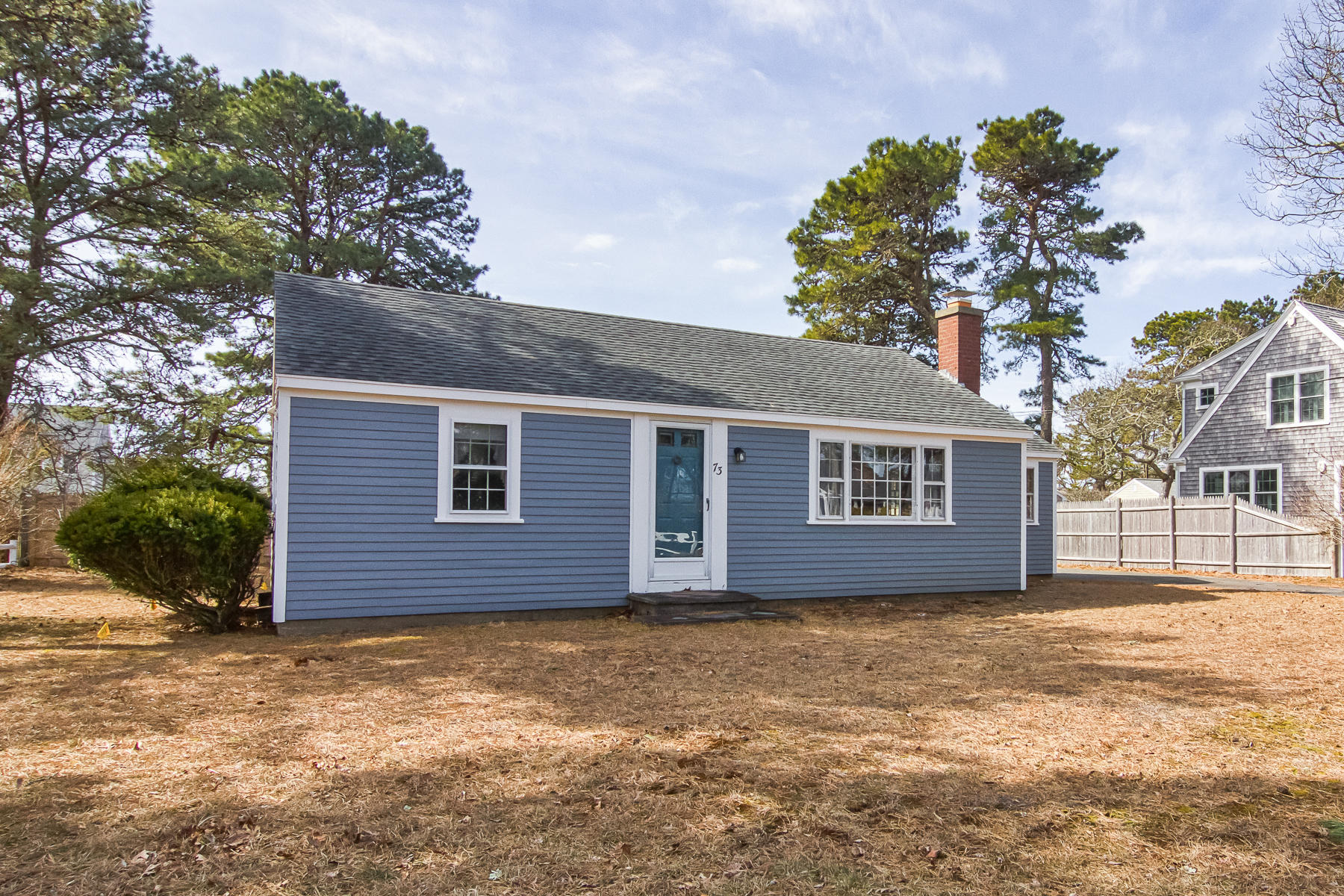 73 Santucket Road West Dennis, MA 02670 - Photo 3 of 36 a front view of a house with a yard and garage