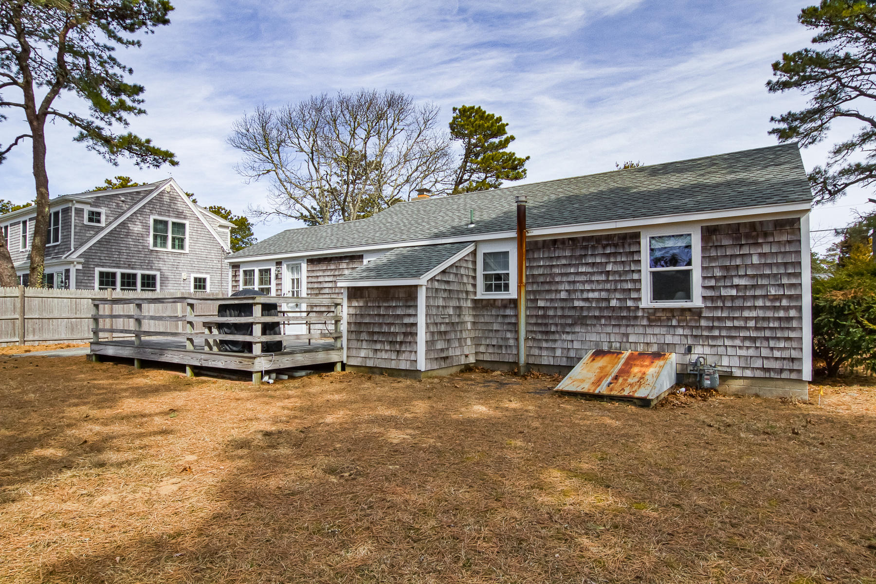 73 Santucket Road West Dennis, MA 02670 - Photo 32 of 36 a view of a house with a yard and sitting area