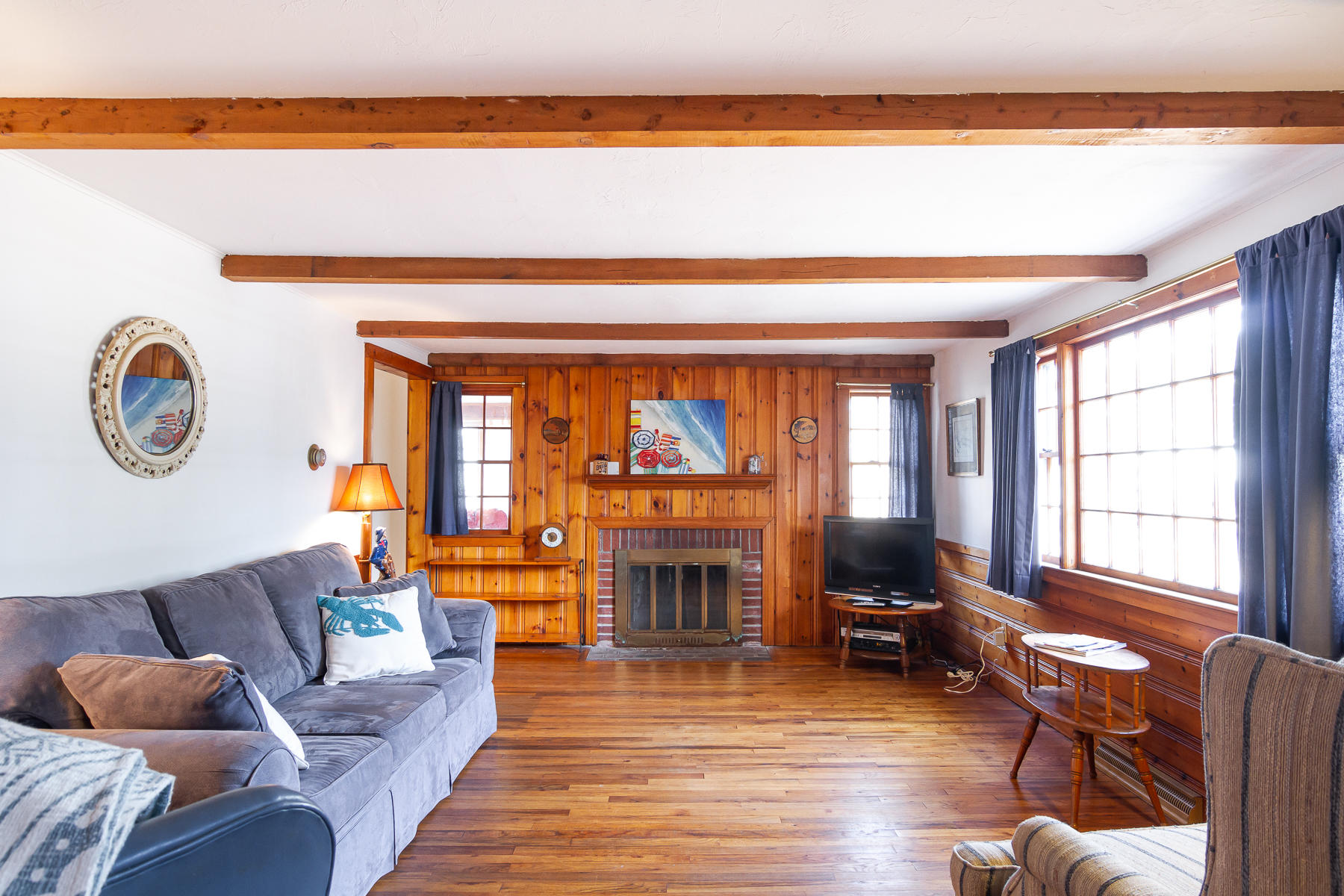 73 Santucket Road West Dennis, MA 02670 - Photo 6 of 36 a living room with furniture and a fireplace