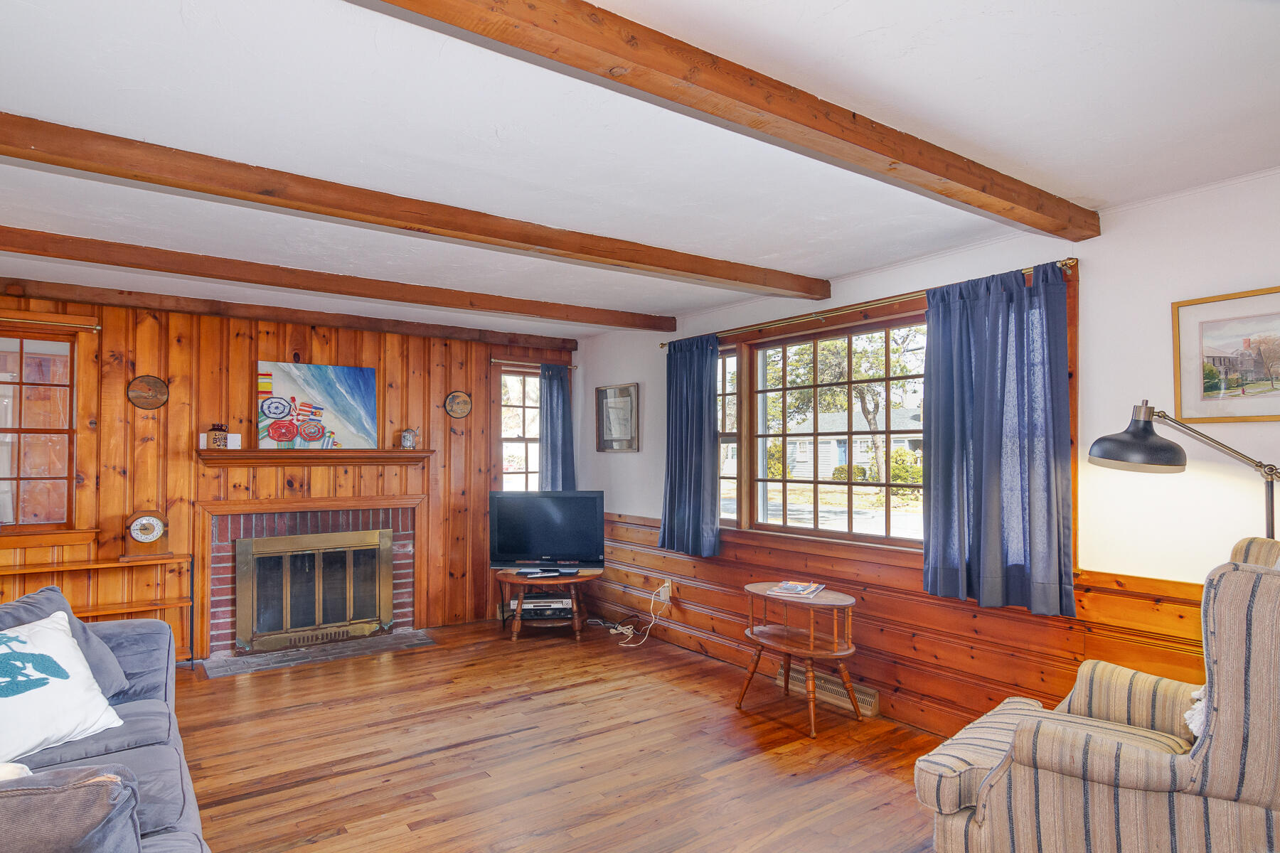 73 Santucket Road West Dennis, MA 02670 - Photo 8 of 36 a living room with furniture a fireplace and a floor to ceiling window
