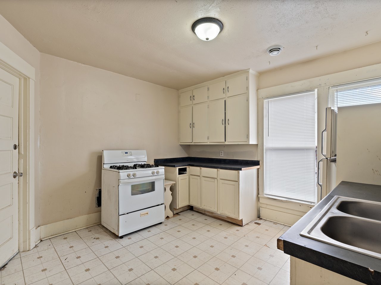 1546 12th Avenue Moline, IL 61265 - Photo 29 of 32 a kitchen with a stove sink and cabinets