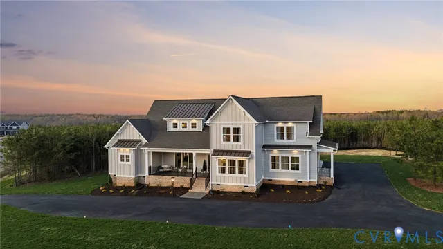 a aerial view of a house with a big yard plants and large trees