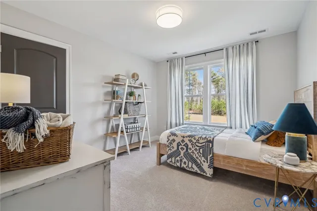 a bedroom with a bed and a chair