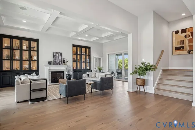 a living room with furniture a fireplace and a potted plant