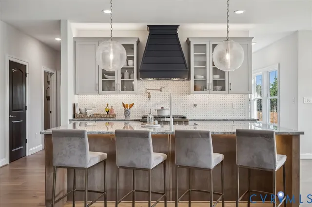 a kitchen with granite countertop a sink and chairs