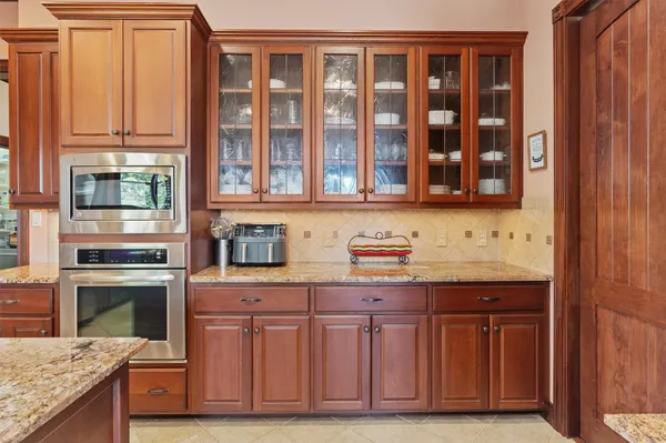 a kitchen with stainless steel appliances granite countertop a stove and cabinets