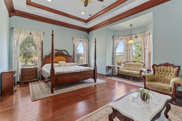 a bedroom with a bed a couch and a window