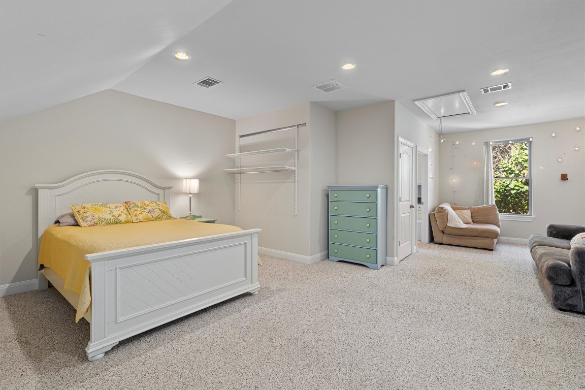 1092 Farm To Market Road 3000 Elgin, TX 78621 - Photo 27 of 40 a spacious bedroom with a bed and a couch