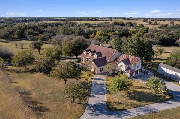an aerial view of a house with a yard