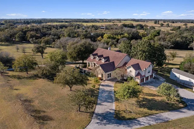 an aerial view of a house with a yard