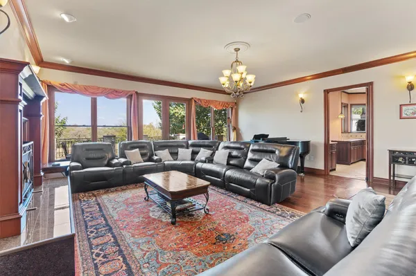 a living room with furniture and a chandelier
