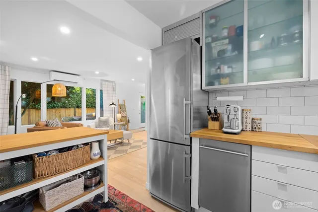 a kitchen with stainless steel appliances a sink and a refrigerator