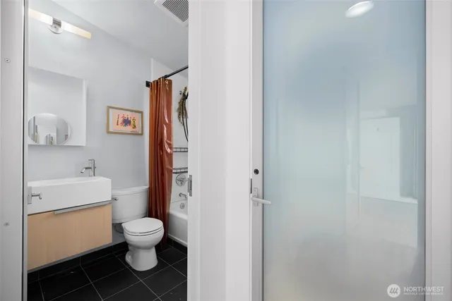 a white toilet sitting next to a bathroom sink