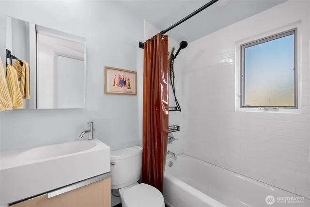 a bathroom with a toilet and a bathtub