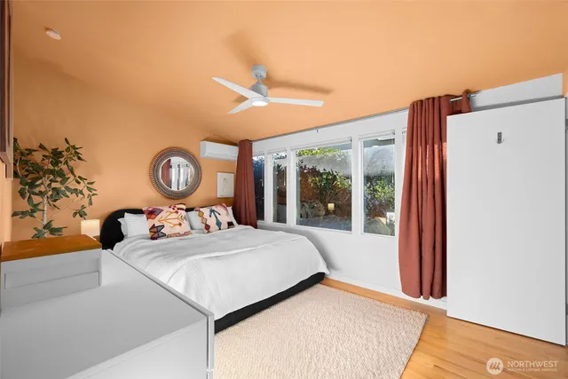 a bedroom with a bed and a large window