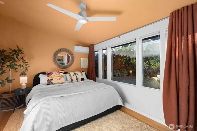 a bedroom with a large bed and a large window