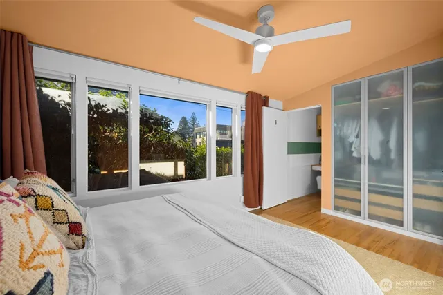 a bedroom with a bed and a large window