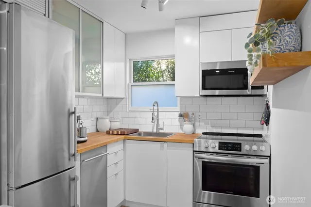a kitchen with a sink stove and microwave