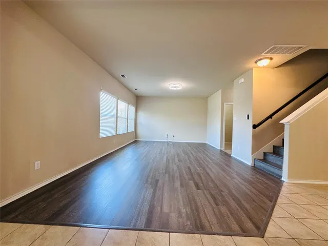 a view of an empty room and wooden floor