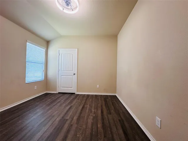 a view of room with window and hardwood floor