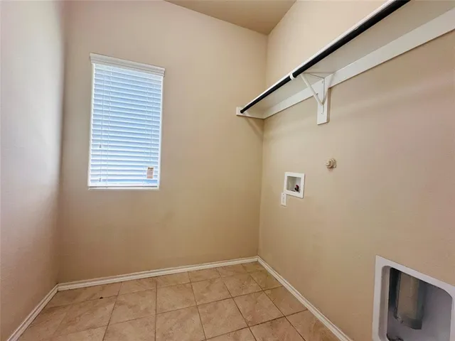 a view of a small space with wooden floor and a window