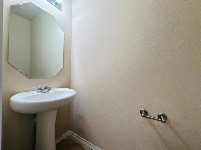a bathroom with a sink a mirror and shower