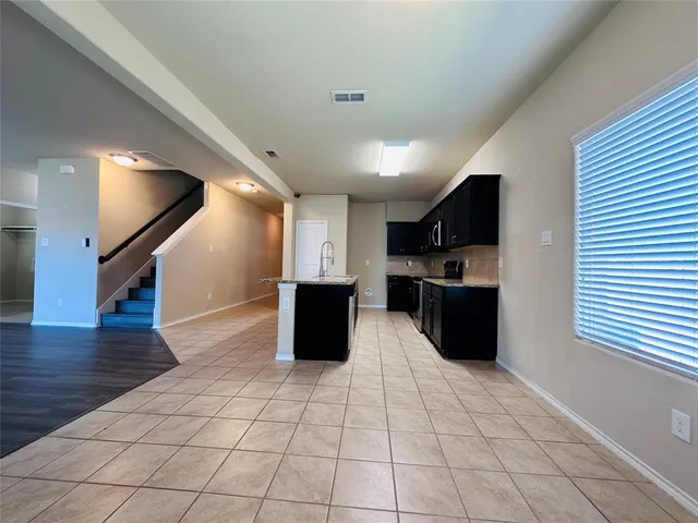 a kitchen with stainless steel appliances a refrigerator sink a microwave and cabinets