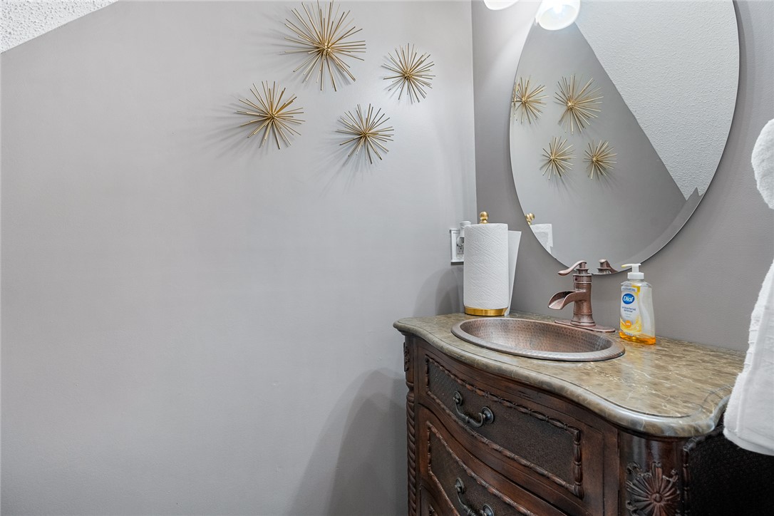 112 C-10-220 Anderson, SC 29621 - Photo 10 of 45 This powder room features a unique vanity with a stone countertop and an elegant copper sink.