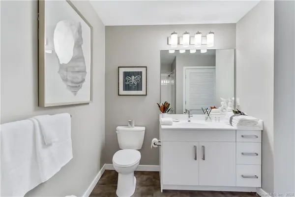 a bathroom with a toilet sink and mirror