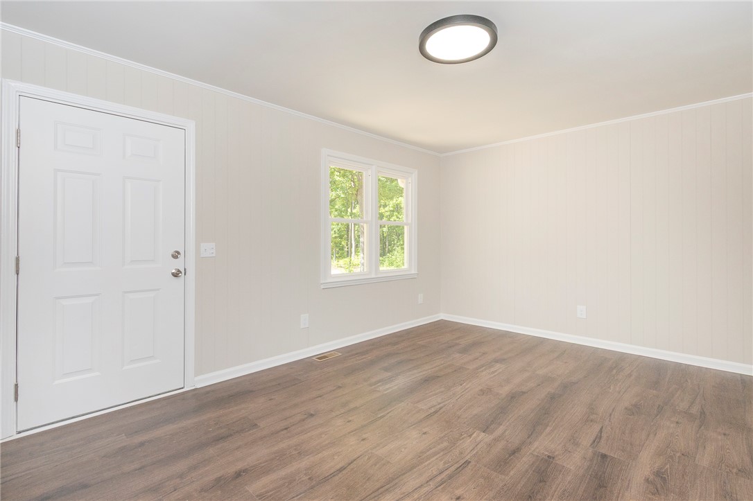 113 Linda Lane Honea Path, SC 29654 - Photo 7 of 36 This bright room features durable flooring and ample natural light, creating a welcoming atmosphere.
