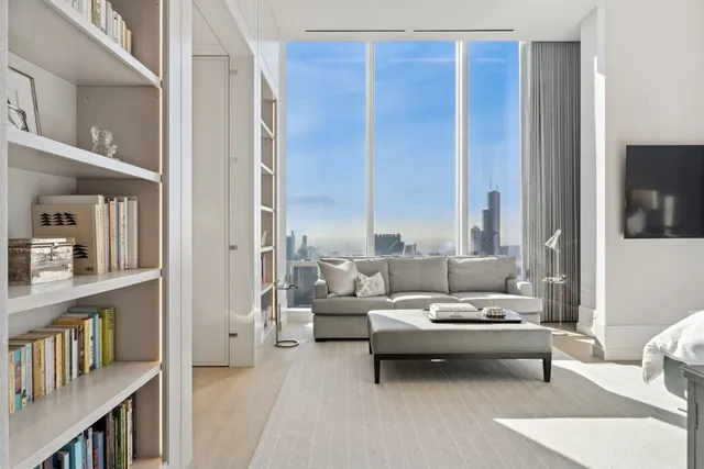 a living room with furniture and a book shelf