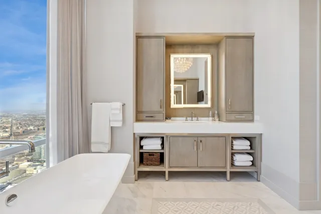 a en suite bathroom with a granite countertop sink and a mirror