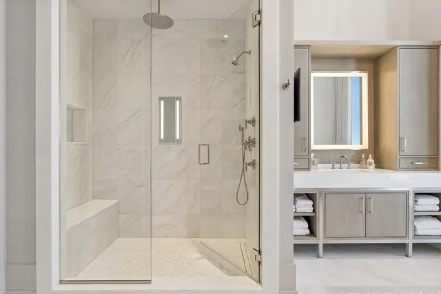 a bathroom with a shower sink and mirror