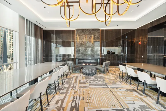 a outdoor space with lots of white furniture and a chandelier