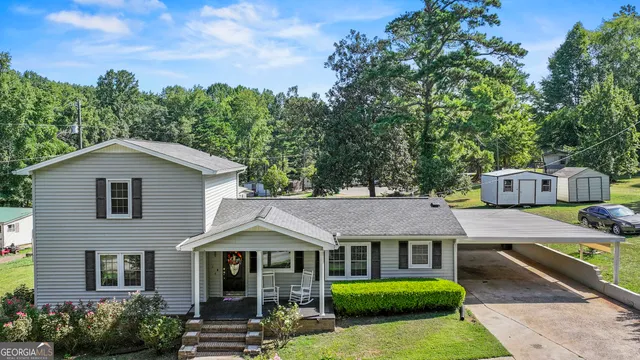 a front view of a house with a garden and plants
