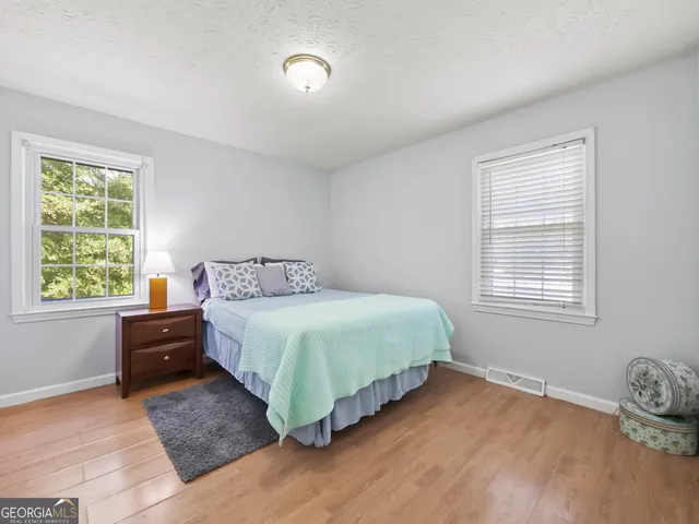 a bedroom with a bed and window