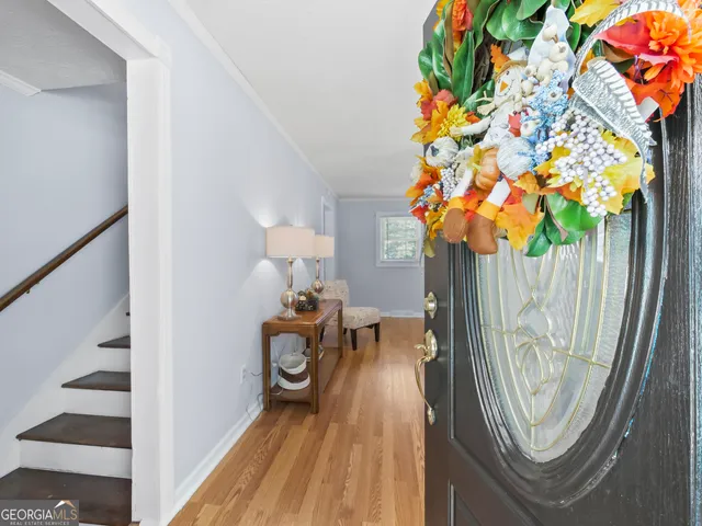a view of a staircase with a flower pot and a rug