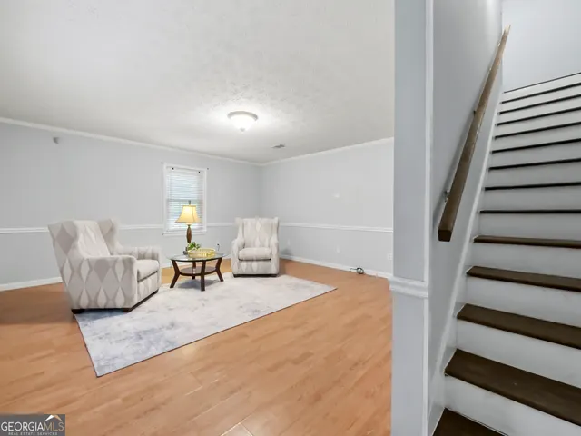 a living room with furniture and stairs