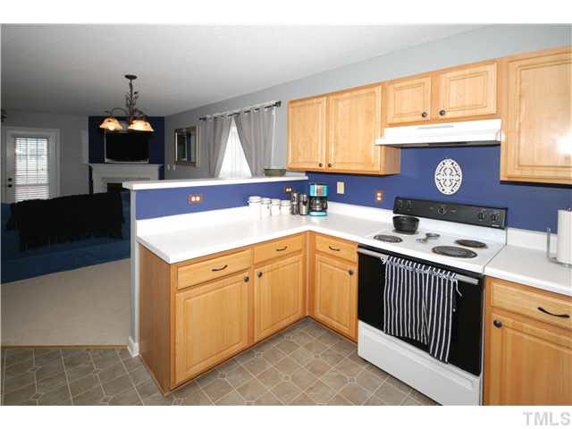 4712 Valley Stream Drive Raleigh, NC 27616 - Photo 11 of 25 a kitchen with a sink stove and cabinets