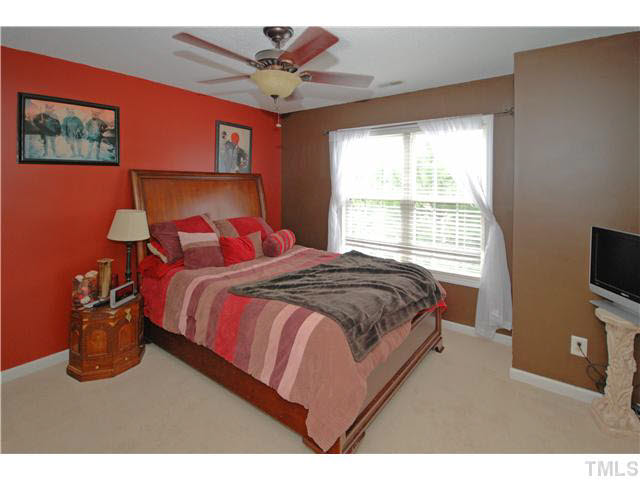 4712 Valley Stream Drive Raleigh, NC 27616 - Photo 14 of 25 a bedroom with a bed a window and a flat screen tv