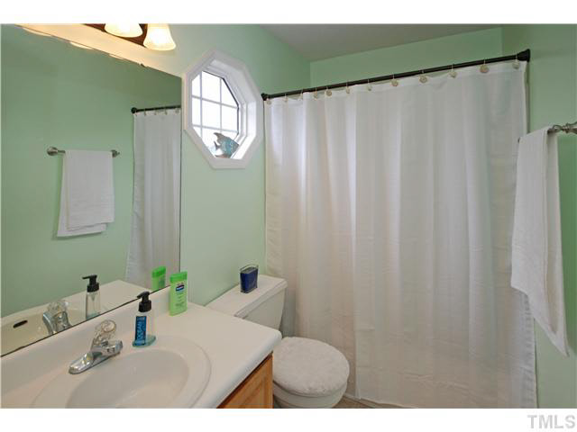 4712 Valley Stream Drive Raleigh, NC 27616 - Photo 16 of 25 a bathroom with a sink and a mirror