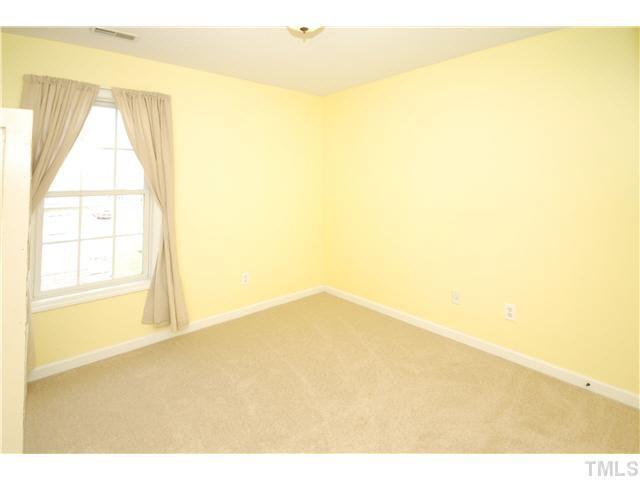 4712 Valley Stream Drive Raleigh, NC 27616 - Photo 17 of 25 a view of empty room with wooden floor and fan