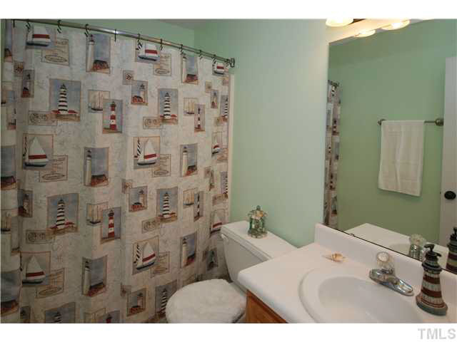 4712 Valley Stream Drive Raleigh, NC 27616 - Photo 18 of 25 a bathroom with a sink and a mirror